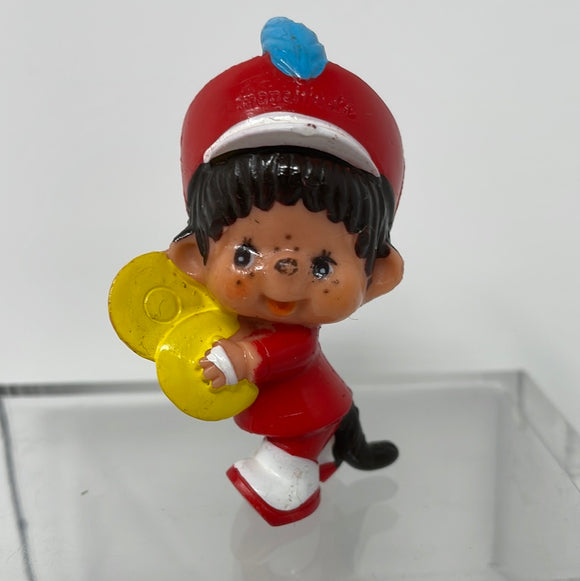 1979 Monchhichi Sekiguchi holding yellow item with blue feather in hat