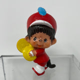 1979 Monchhichi Sekiguchi holding yellow item with blue feather in hat